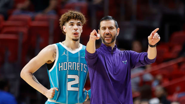 Charlotte Hornets guard LaMelo Ball (2) and head coach James Borrego talk during a time out in the first half against the Miami Heat at FTX Arena.